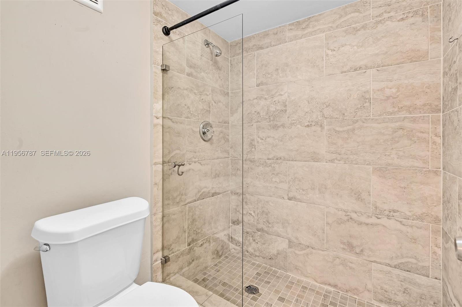 400 Commodore Drive, Unit 215 Plantation, FL 33325 - Photo 25 of 30 a bathroom with a toilet and shower