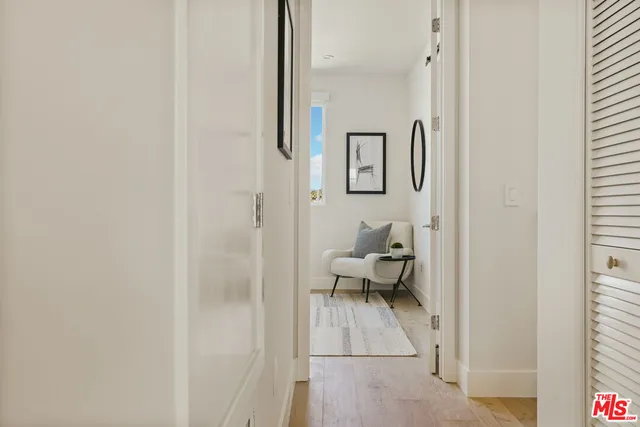 a living room with furniture and a painting on the wall