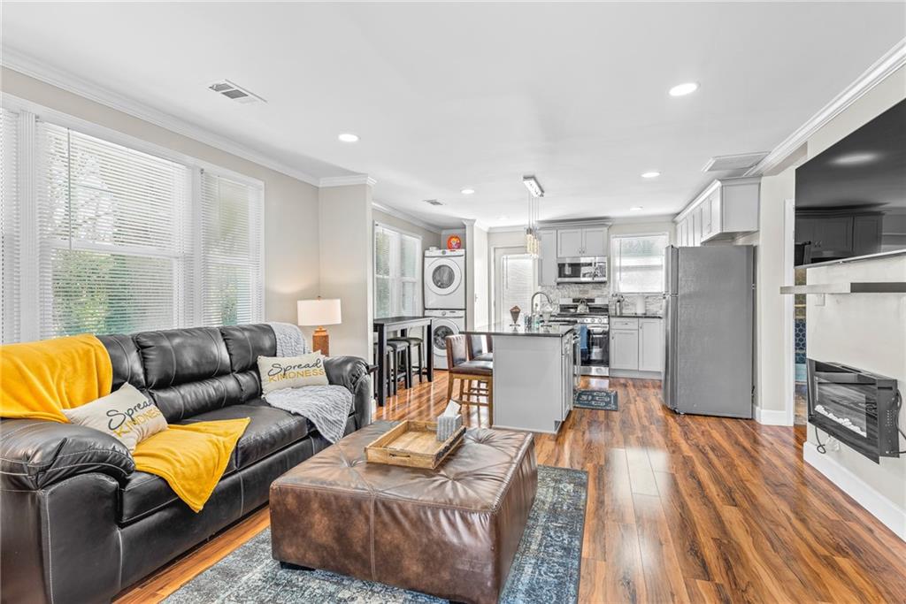 1298 Douglas Street Southwest, Unit A Atlanta, GA 30314 - Photo 1 of 11 a living room with furniture and a flat screen tv