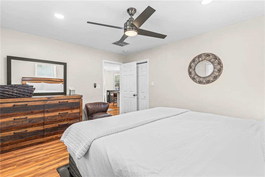 1298 Douglas Street Southwest, Unit A Atlanta, GA 30314 - Photo 7 of 11 a bedroom with a bed and a chandelier