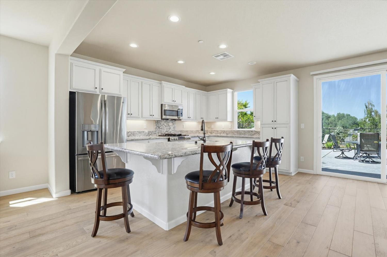 21456 Rucker Court Grass Valley, CA 95949 - Photo 21 of 74 a kitchen with kitchen island a dining table chairs stainless steel appliances and cabinets