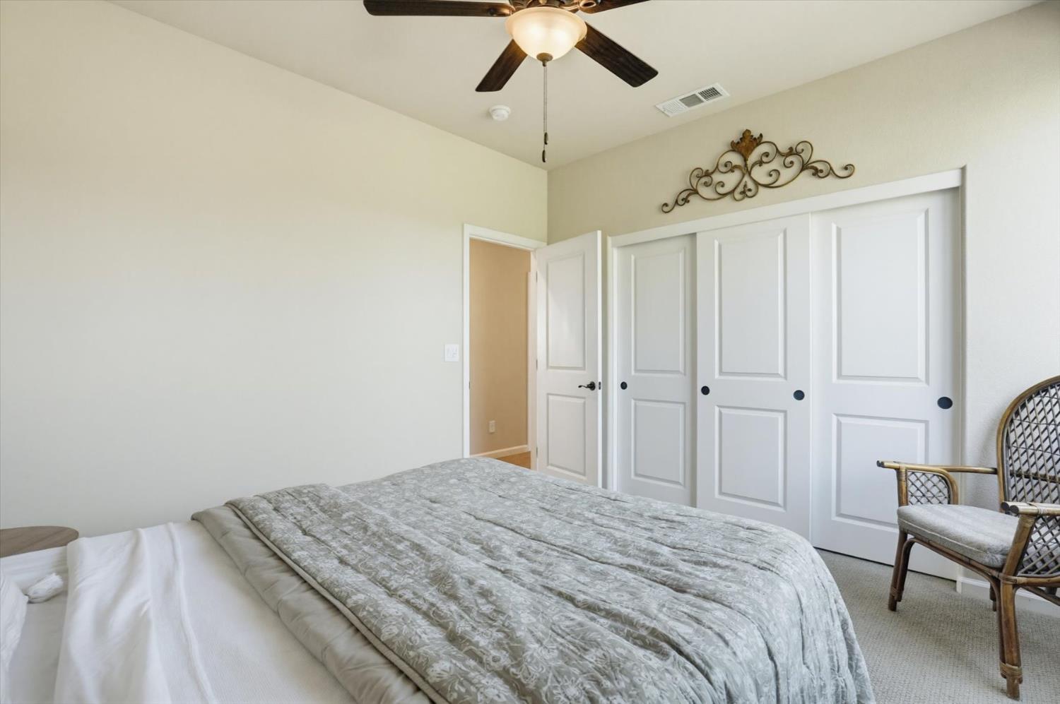 21456 Rucker Court Grass Valley, CA 95949 - Photo 26 of 74 a bedroom with a bed and a chandelier