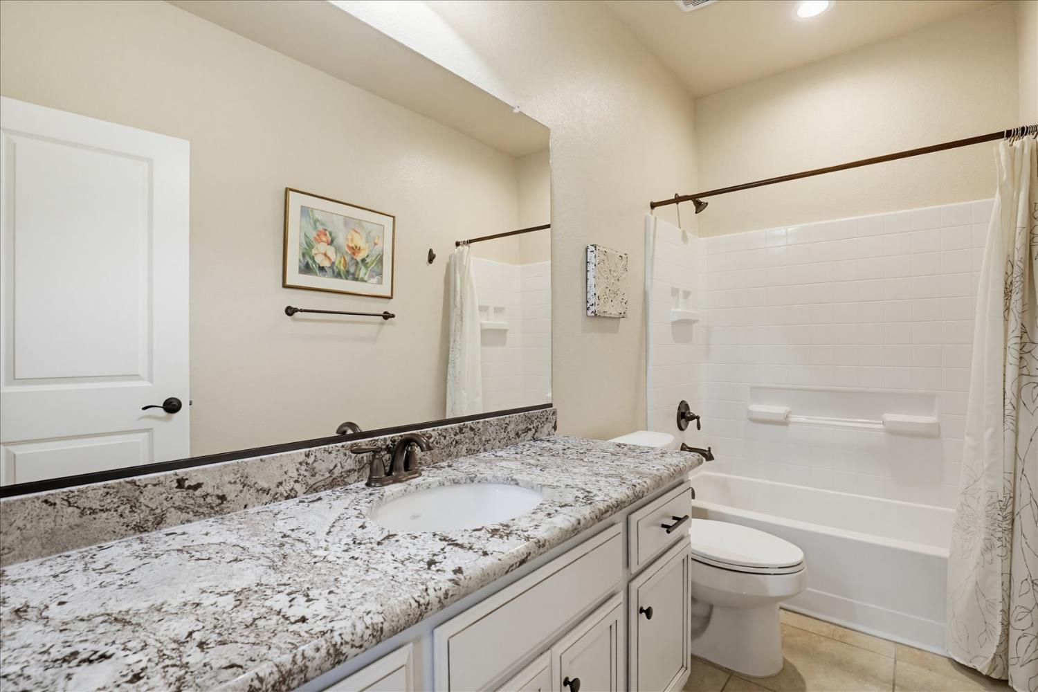 21456 Rucker Court Grass Valley, CA 95949 - Photo 28 of 74 a bathroom with a granite countertop sink toilet and shower