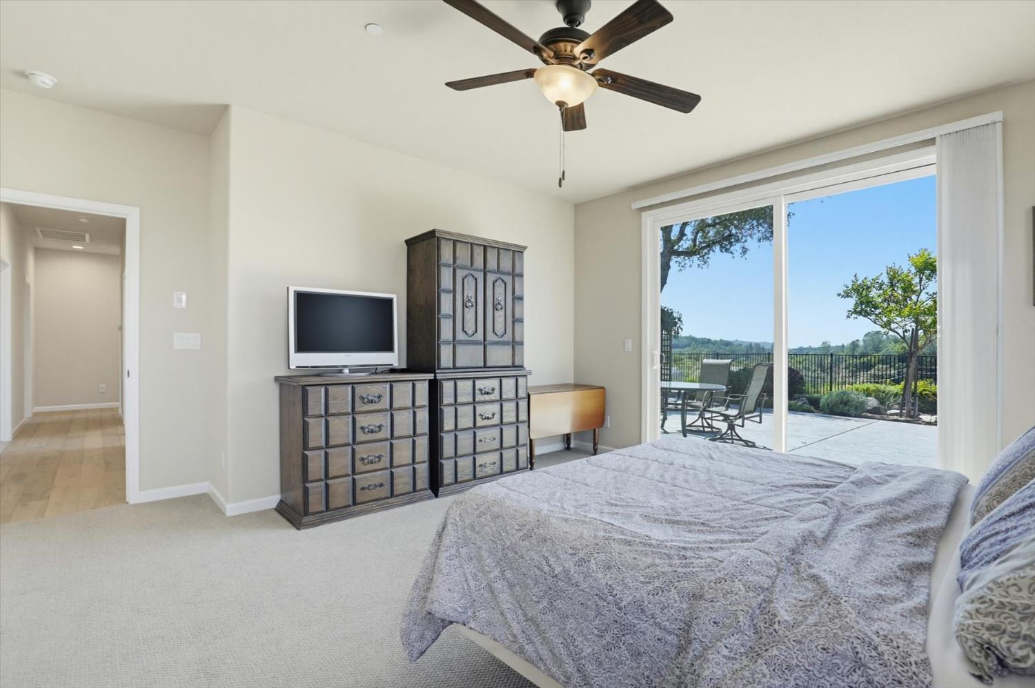21456 Rucker Court Grass Valley, CA 95949 - Photo 38 of 74 a bedroom with a large bed and a flat tv screen on dresser