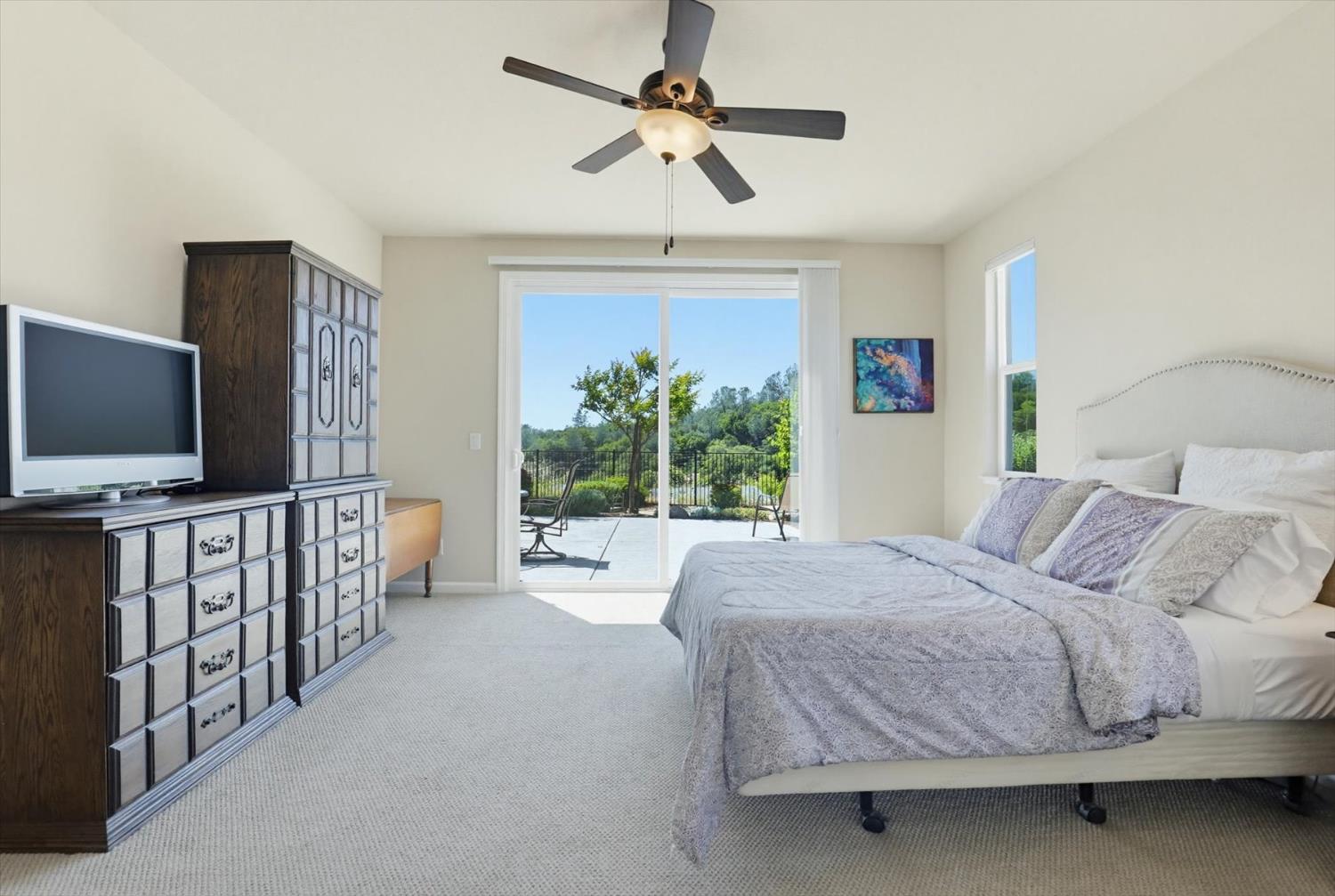 21456 Rucker Court Grass Valley, CA 95949 - Photo 39 of 74 a bedroom with a large bed and a flat tv screen on dresser