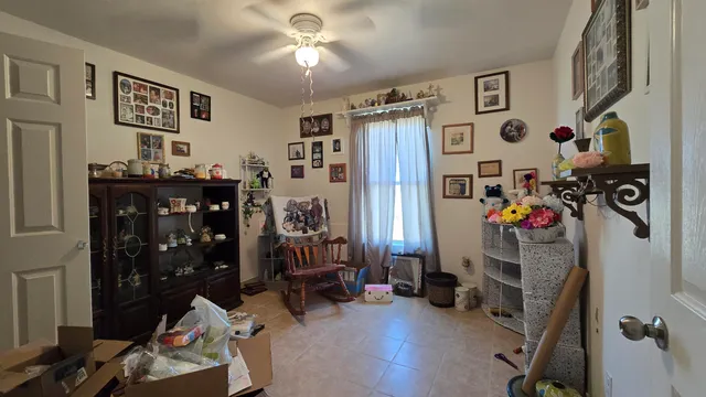 a living room with furniture and baby bed