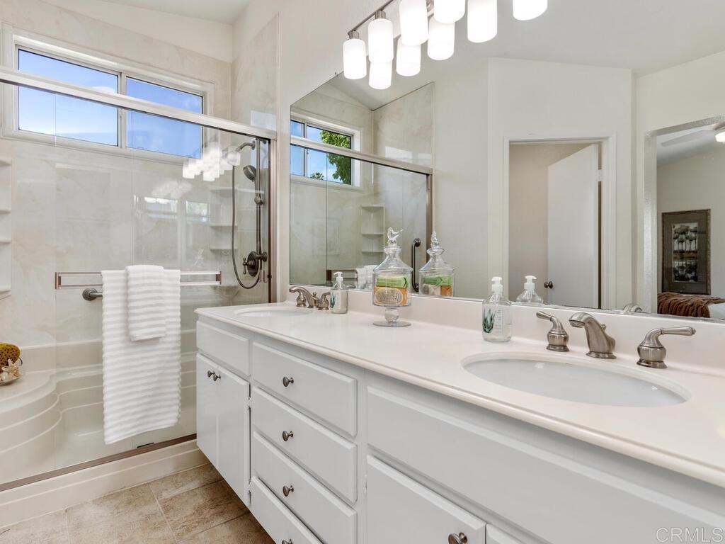 1219 Sunglow Drive Oceanside, CA 92056 - Photo 24 of 40 The Primary Bathroom has a dual sink vanity, new lighting & a step in shower.