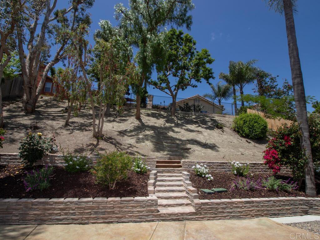1219 Sunglow Drive Oceanside, CA 92056 - Photo 35 of 40 The stone retaining wall & stairs with the colorful bushes is the perfect backdrop