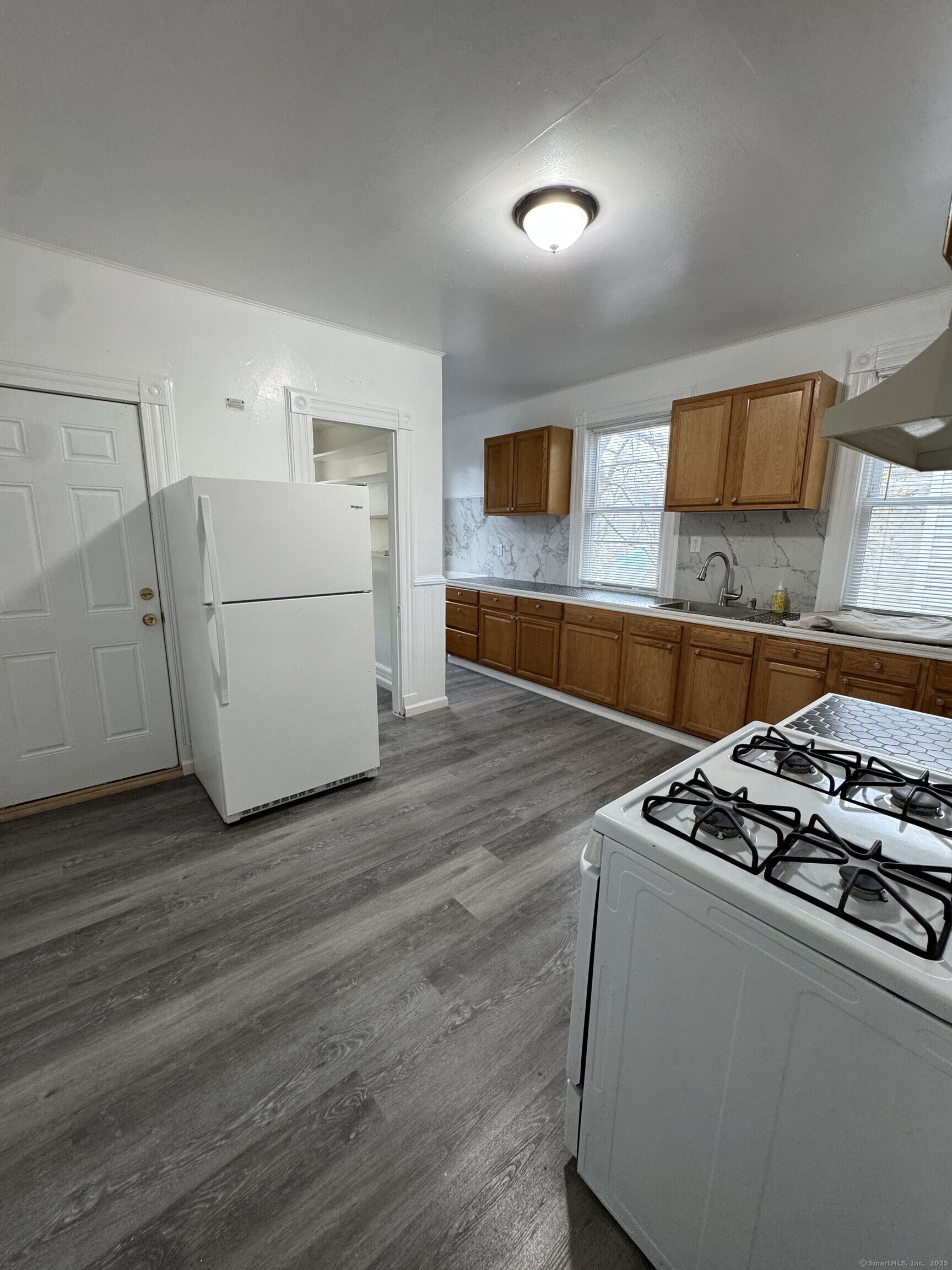 Undisclosed Address New Haven, CT 06511 - Photo 3 of 7 a kitchen with granite countertop a stove a sink and a microwave