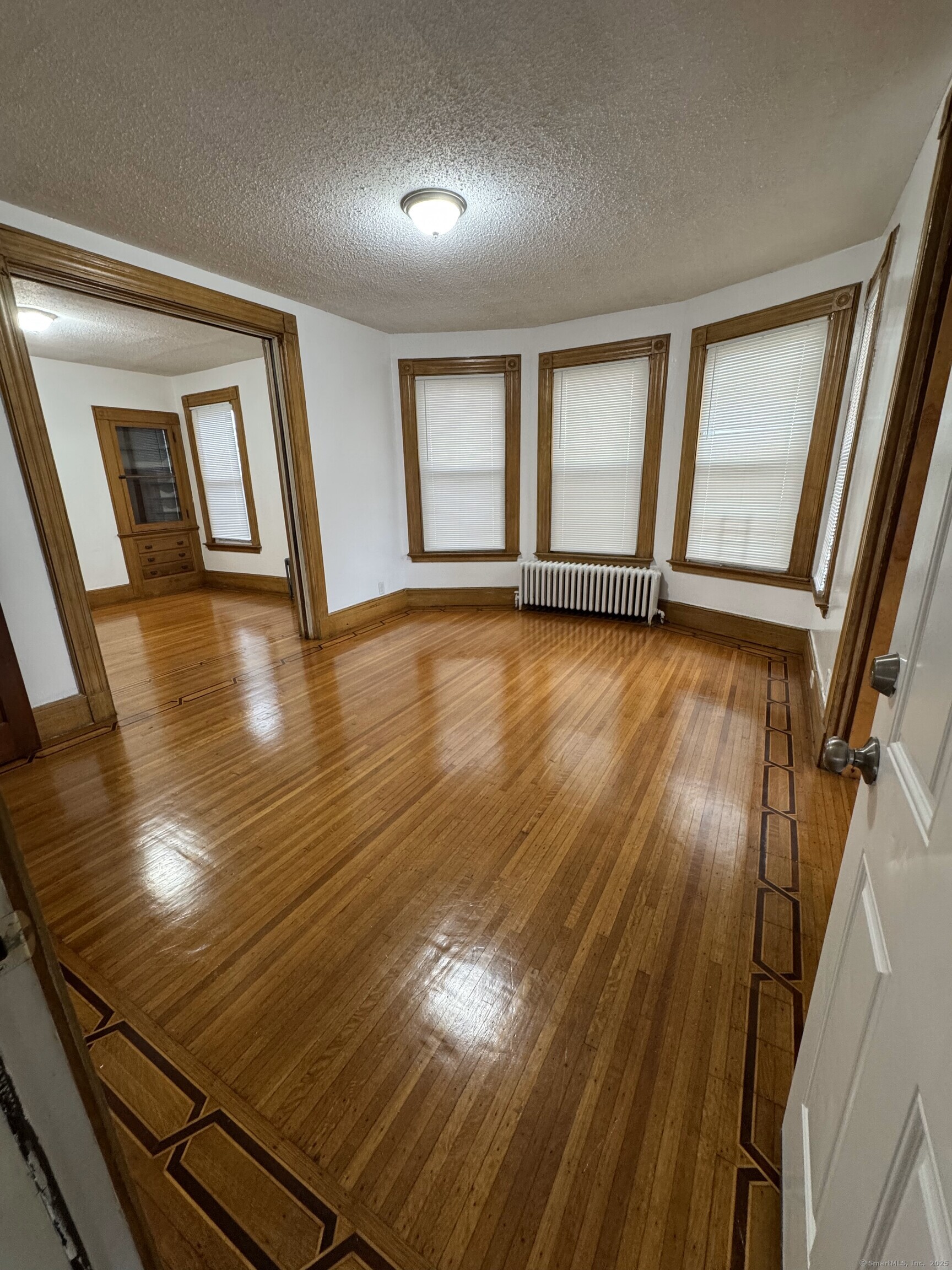 Undisclosed Address New Haven, CT 06511 - Photo 6 of 7 wooden floor in an empty room with a window