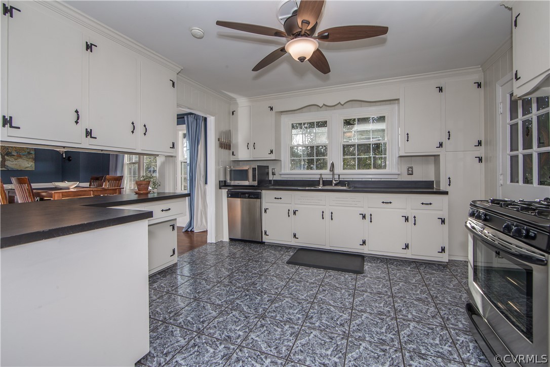 3921 Wakefield Road Richmond, VA 23235 - Photo 16 of 50 a kitchen with stainless steel appliances granite countertop a stove a sink and a refrigerator