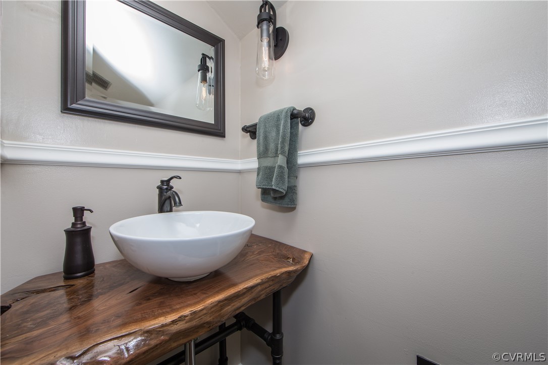 3921 Wakefield Road Richmond, VA 23235 - Photo 27 of 50 a bathroom with a sink a mirror and vanity