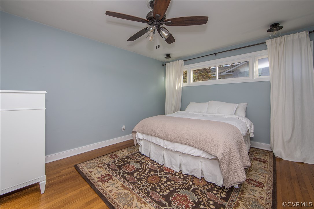 3921 Wakefield Road Richmond, VA 23235 - Photo 37 of 50 a bedroom with a bed and a chandelier
