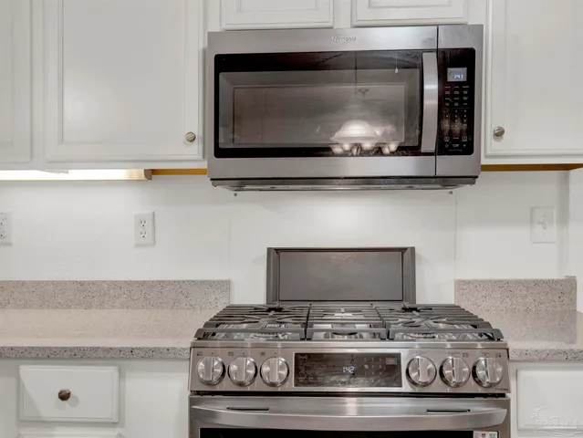 a view of a workspace with furniture and wooden floor