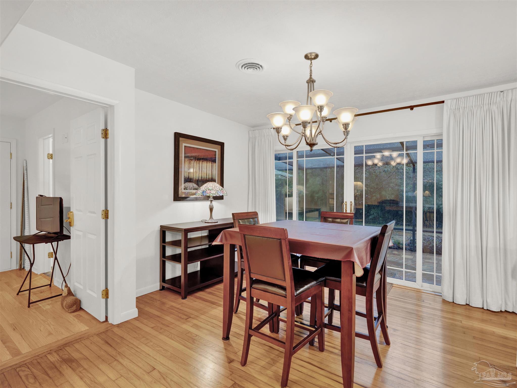 111 Euclid Road Pensacola, FL 32503 - Photo 16 of 34 a view of a dining room with furniture window and wooden floor