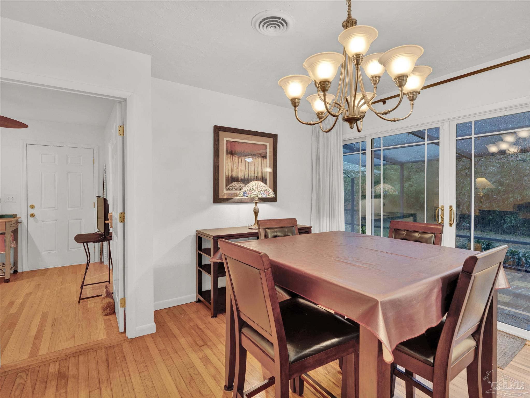 111 Euclid Road Pensacola, FL 32503 - Photo 18 of 34 a dining room filled chandelier and wooden floor