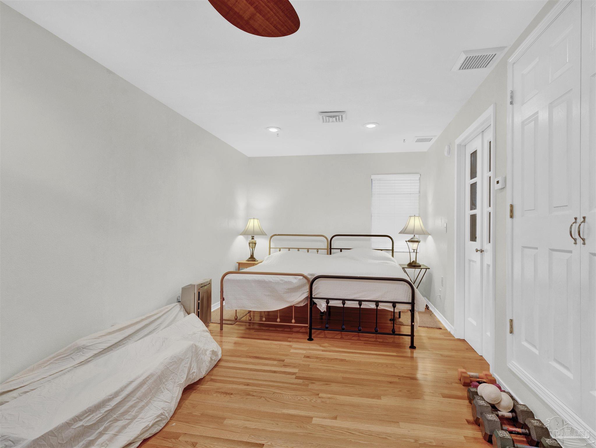 111 Euclid Road Pensacola, FL 32503 - Photo 2 of 34 a spacious bedroom with a bed and a wooden floor