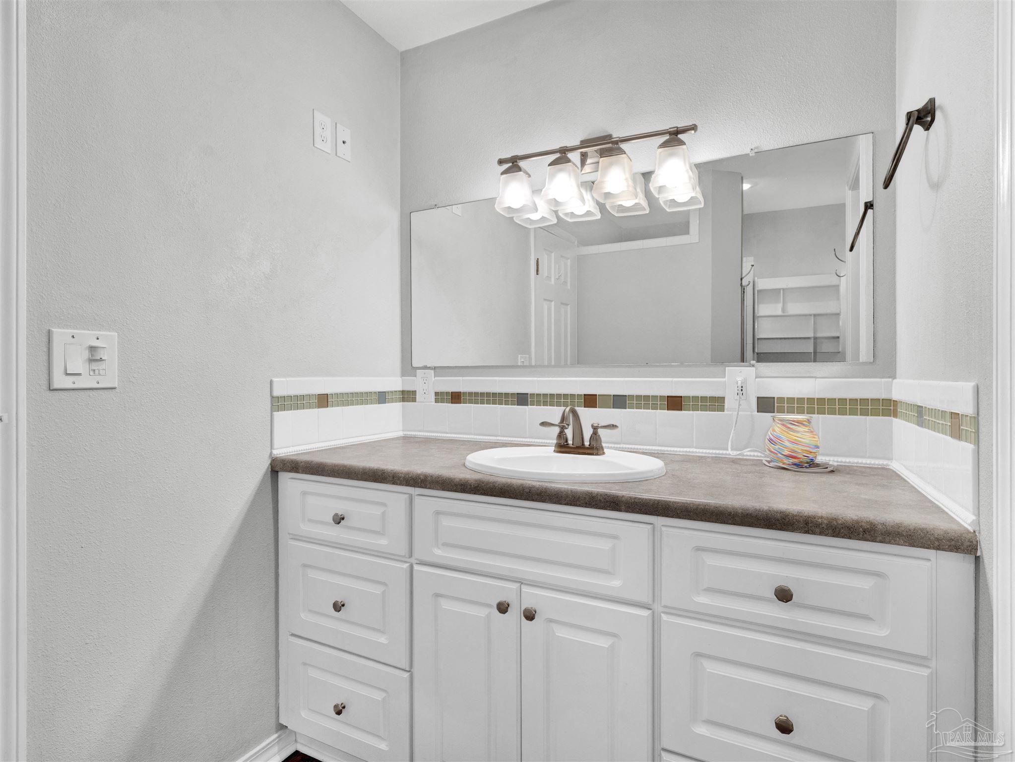 111 Euclid Road Pensacola, FL 32503 - Photo 3 of 34 a bathroom with a sink and a mirror