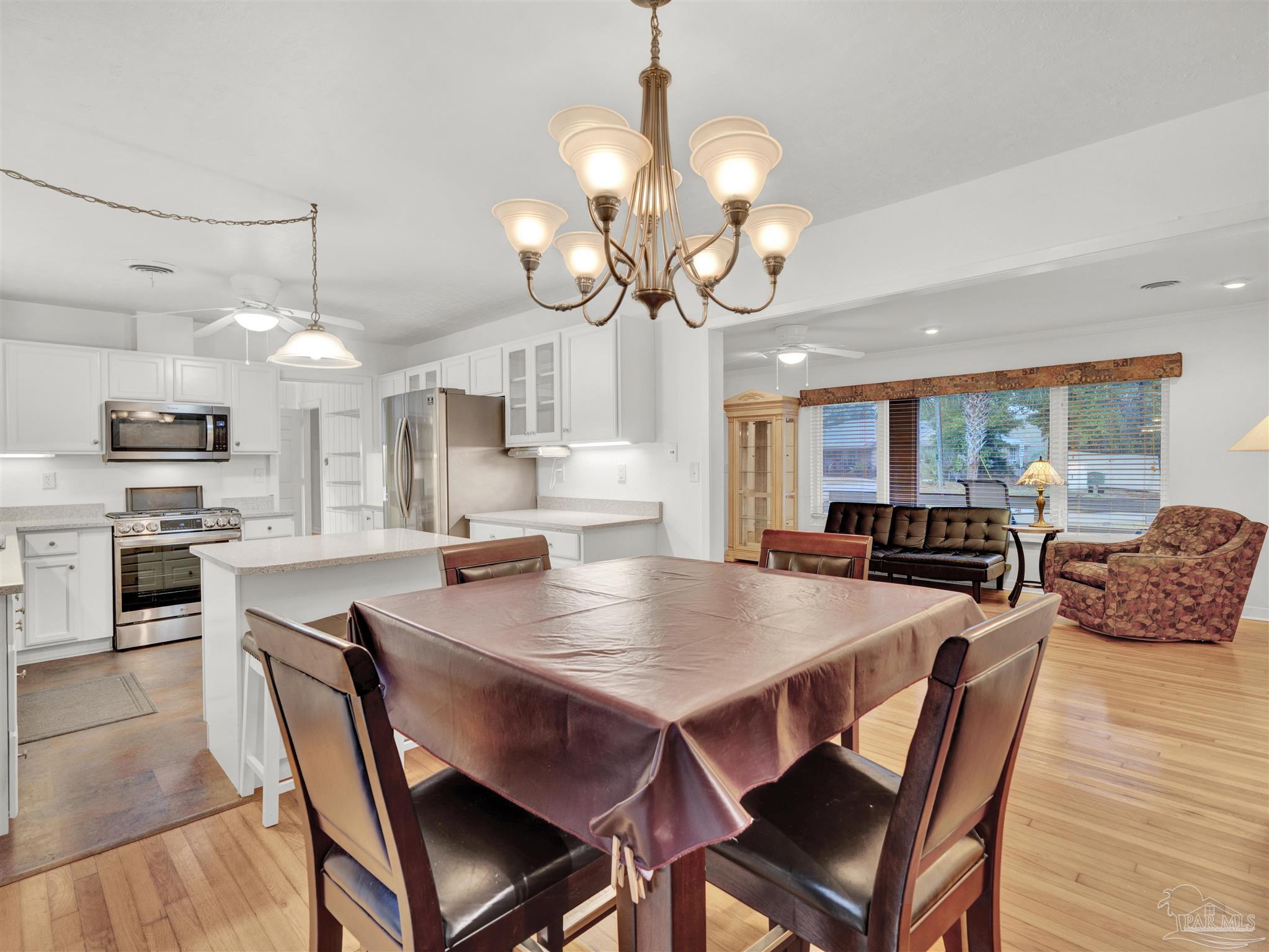 111 Euclid Road Pensacola, FL 32503 - Photo 6 of 34 a view of a dining room with furniture large wooden floor and chandelier
