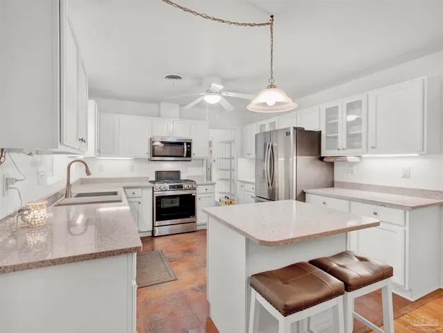 a dining room filled chandelier and wooden floor