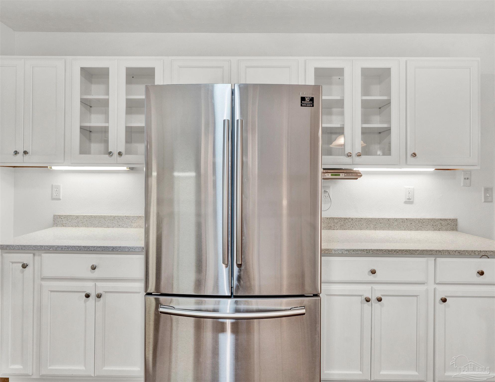 111 Euclid Road Pensacola, FL 32503 - Photo 9 of 34 a kitchen with cabinets and a refrigerator