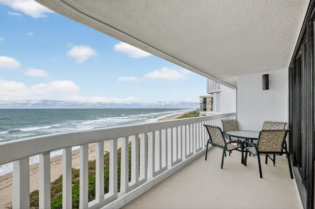 a spacious bedroom with a bed and a lamp