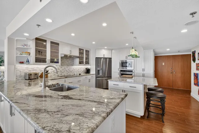 a living room with furniture flat screen tv and wooden floor