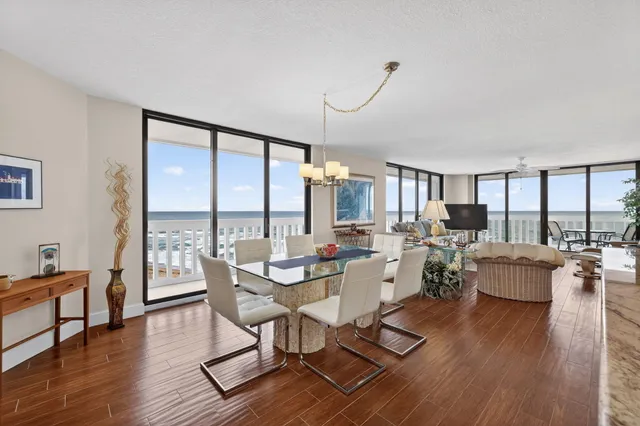 a view of a chairs and table in the balcony