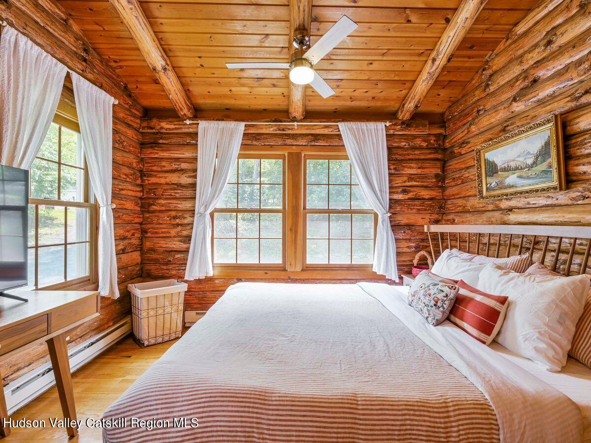 104 Hunter Lane Hunter, NY 12442 - Photo 14 of 36 a bedroom with furniture and a large window