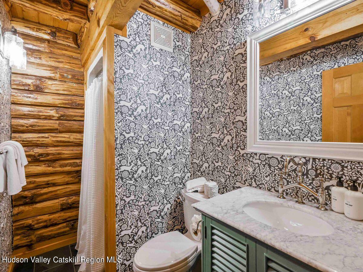 104 Hunter Lane Hunter, NY 12442 - Photo 15 of 36 a bathroom with a granite countertop sink and a toilet