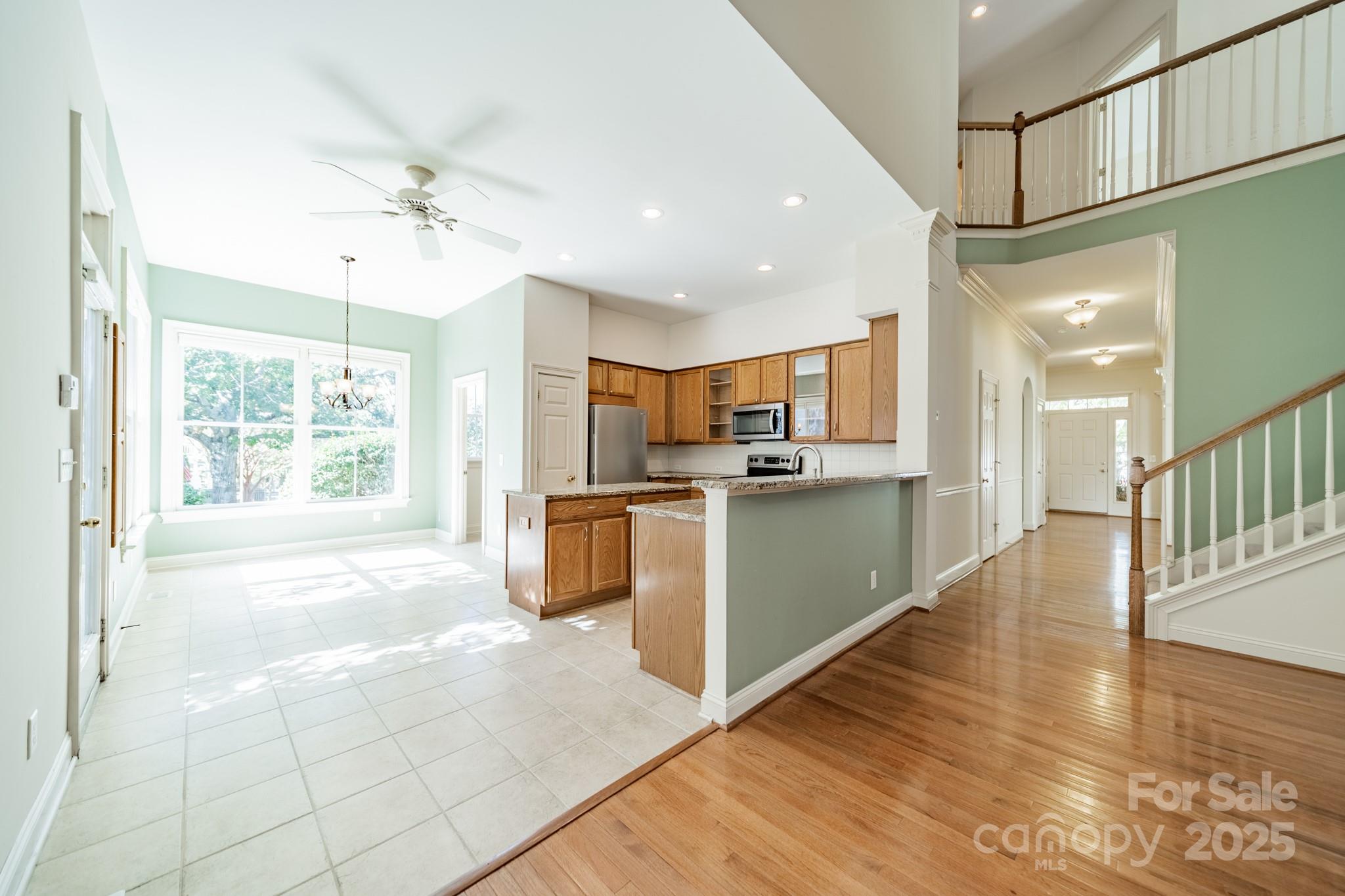 545 Glen Walk Drive Fort Mill, SC 29708 - Photo 13 of 48 a large kitchen with stainless steel appliances kitchen island granite countertop a large counter top and a chandelier