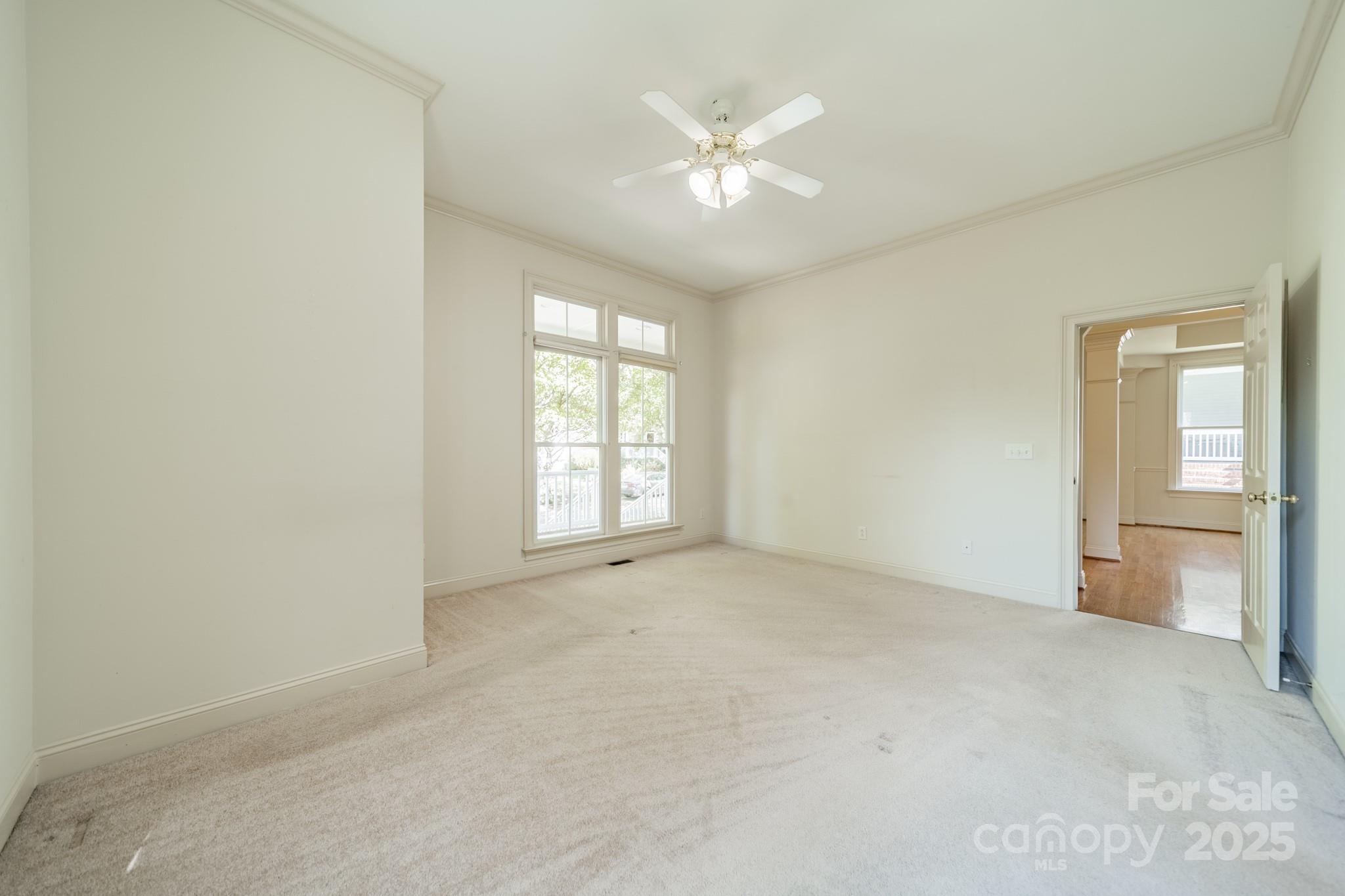 545 Glen Walk Drive Fort Mill, SC 29708 - Photo 23 of 48 an empty room with windows and chandelier fan