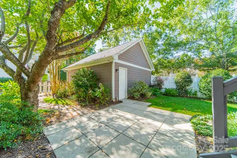 a view of a house with a tree in the yard