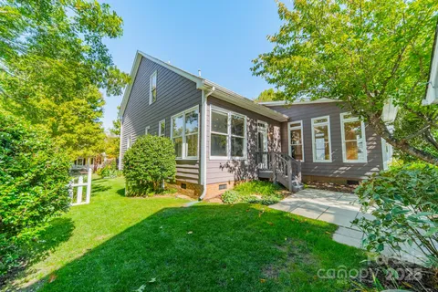 a view of a house with a yard and sitting area