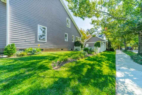 a view of a house with a yard and a garden