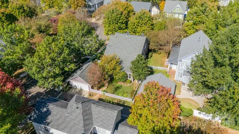 an aerial view of a house with a yard and plants
