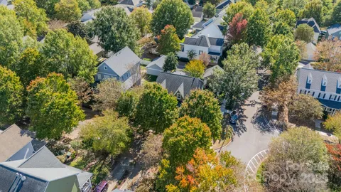 an aerial view of multiple houses with yard