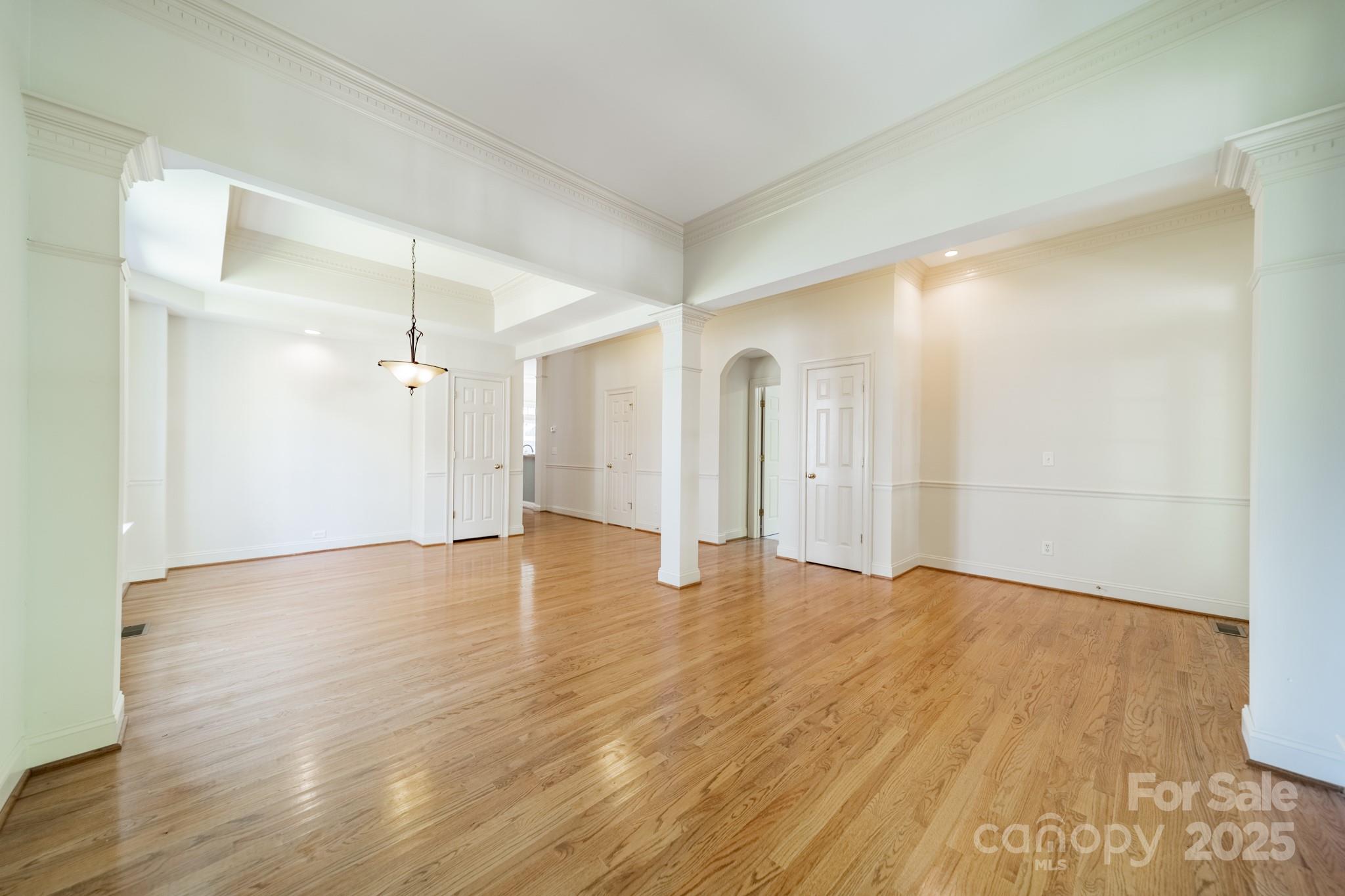 545 Glen Walk Drive Fort Mill, SC 29708 - Photo 8 of 48 a view of a big room with wooden floor and windows