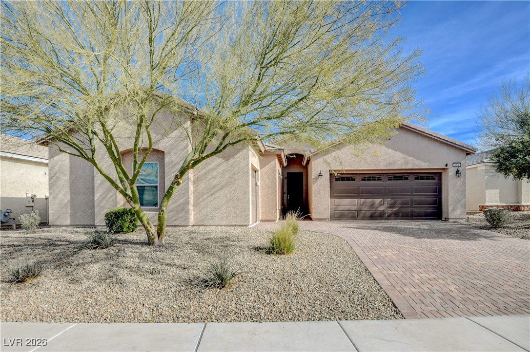 Single story home surrounded by all one story homes and a backyard yard that is elevated above the home behind it.