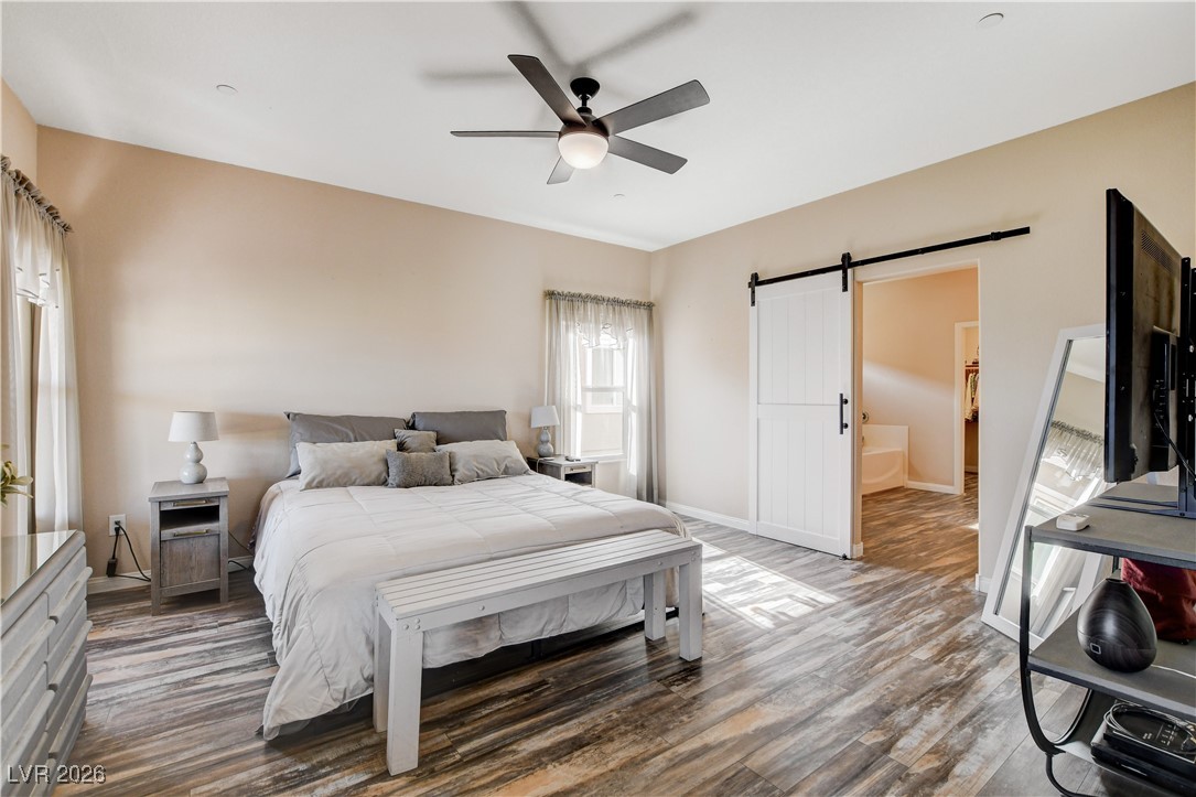 964 Cutter Street Henderson, NV 89011 - Photo 19 of 52 Copious primary suite with sliding door to the backyard, ceiling fan and a spacious walk-in closet.