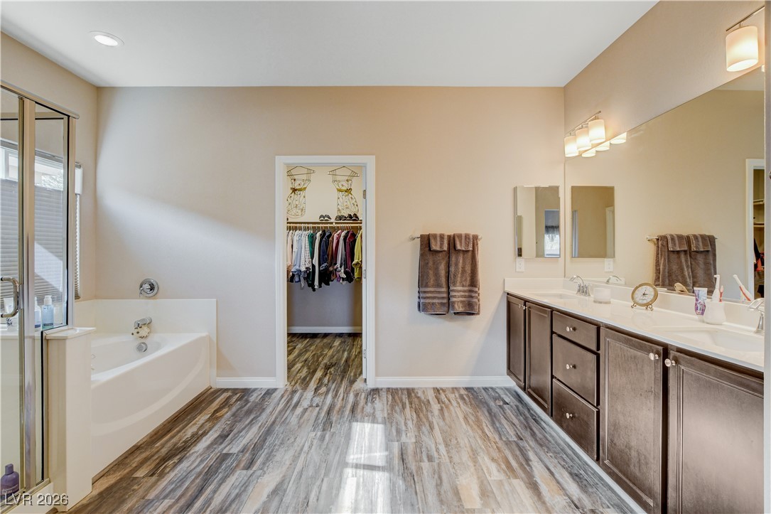 964 Cutter Street Henderson, NV 89011 - Photo 22 of 52 Spa retreat primary bathroom with separate garden tub, walk-in shower and huge vanity with double sinks and an abundance of cabinets.