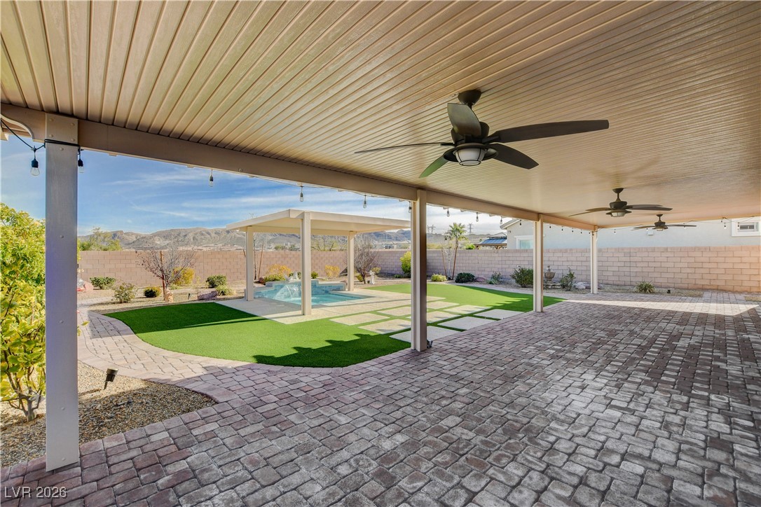 964 Cutter Street Henderson, NV 89011 - Photo 41 of 52 Covered patio is the full width of the home with ceiling fans and lighting.