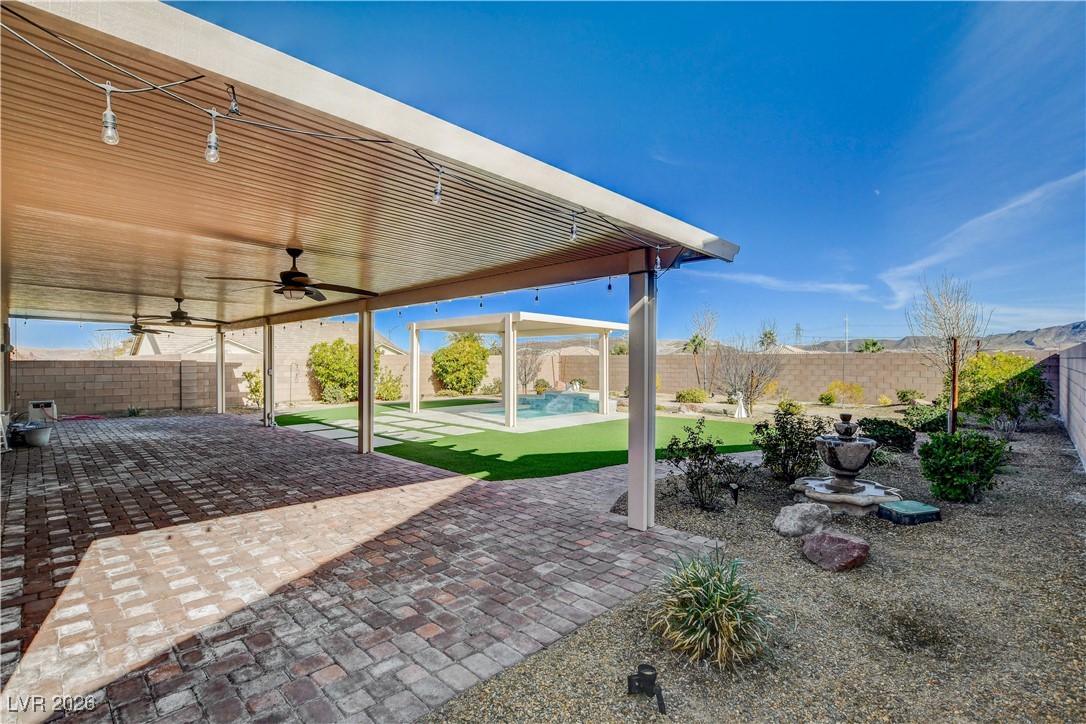 964 Cutter Street Henderson, NV 89011 - Photo 42 of 52 Almost a quarter acre lot, this backyard has lots of paver walkways, synthetic grass and a covered "Spool" (combination pool/spa) with a waterfall. Mature landscaping, great mountain views and a soothing fountain.