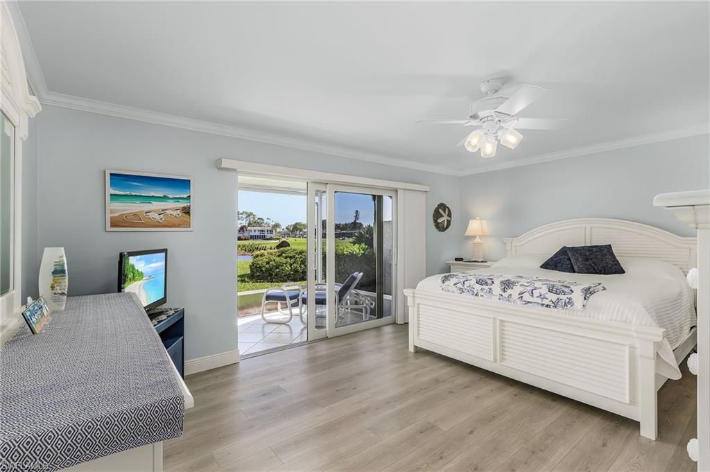 237 Palm Drive, Unit 1 Naples, FL 34112 - Photo 12 of 30 a living room with furniture white walls and wooden floor