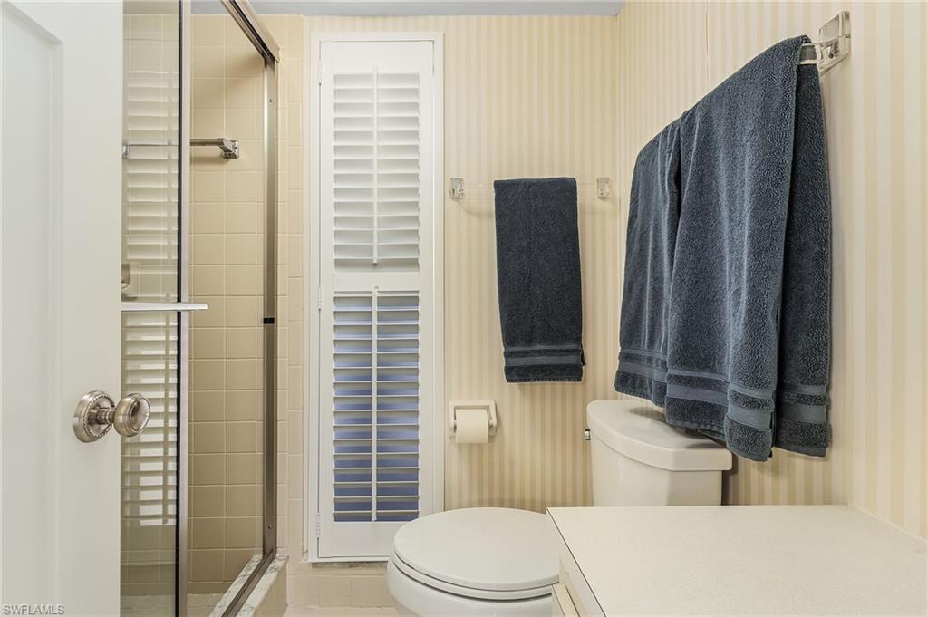 237 Palm Drive, Unit 1 Naples, FL 34112 - Photo 17 of 30 a bathroom with a toilet and shower