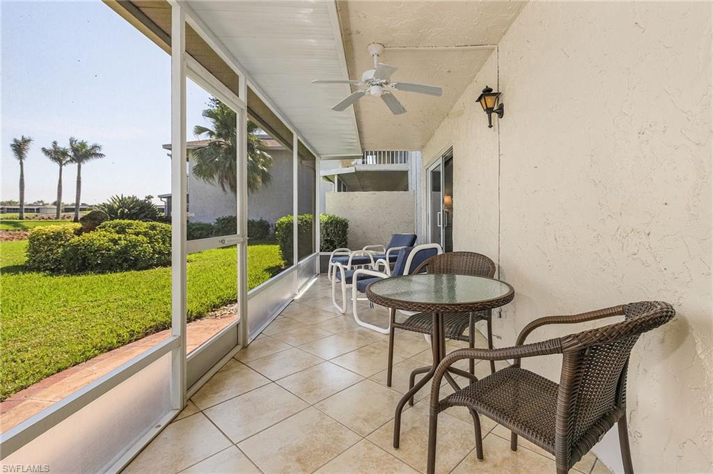 237 Palm Drive, Unit 1 Naples, FL 34112 - Photo 22 of 30 a view of a chair and tables in the patio