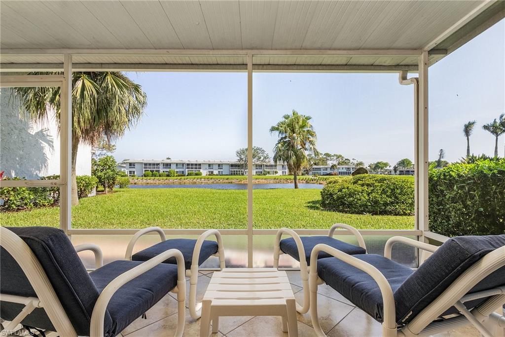 237 Palm Drive, Unit 1 Naples, FL 34112 - Photo 24 of 30 a view of a patio with couches potted plants and a big yard