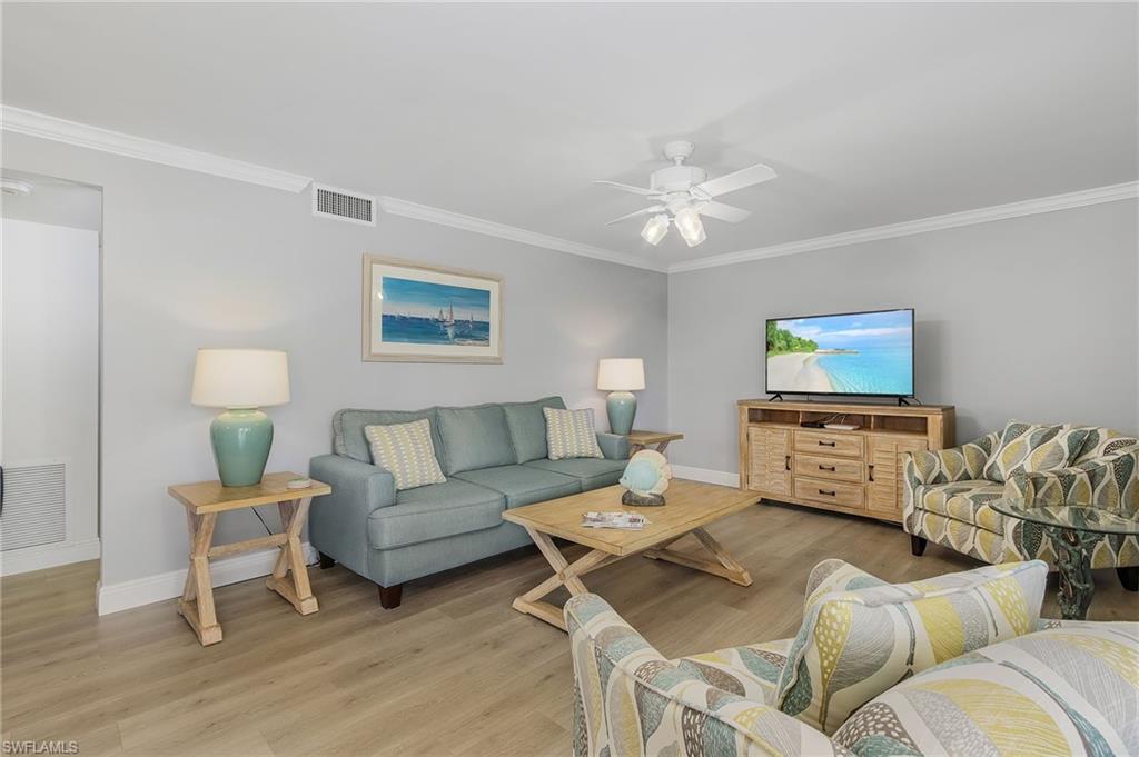 237 Palm Drive, Unit 1 Naples, FL 34112 - Photo 4 of 30 a living room with furniture and a flat screen tv