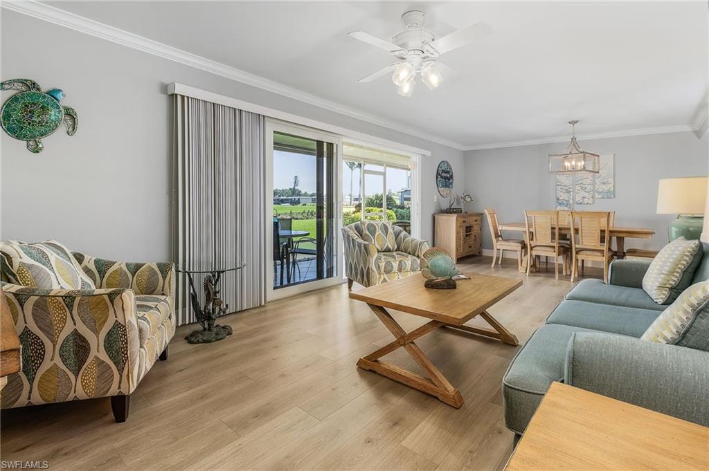 237 Palm Drive, Unit 1 Naples, FL 34112 - Photo 5 of 30 a living room with furniture and a wooden floor