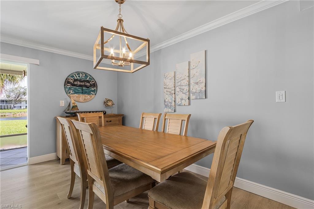 237 Palm Drive, Unit 1 Naples, FL 34112 - Photo 8 of 30 a view of a dining room with furniture and wooden floor